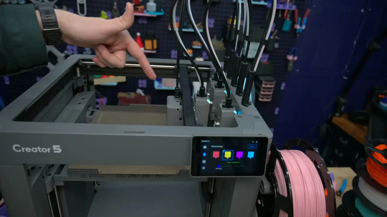 Flashforge Creator 5 open frame with parked tools, a front touchscreen, and a pink filament spool on the right