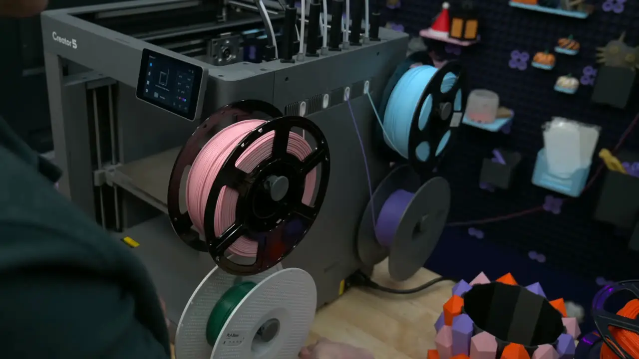 Several filament spools mounted on the right side of the Creator 5, with feed tubes running up to its tools