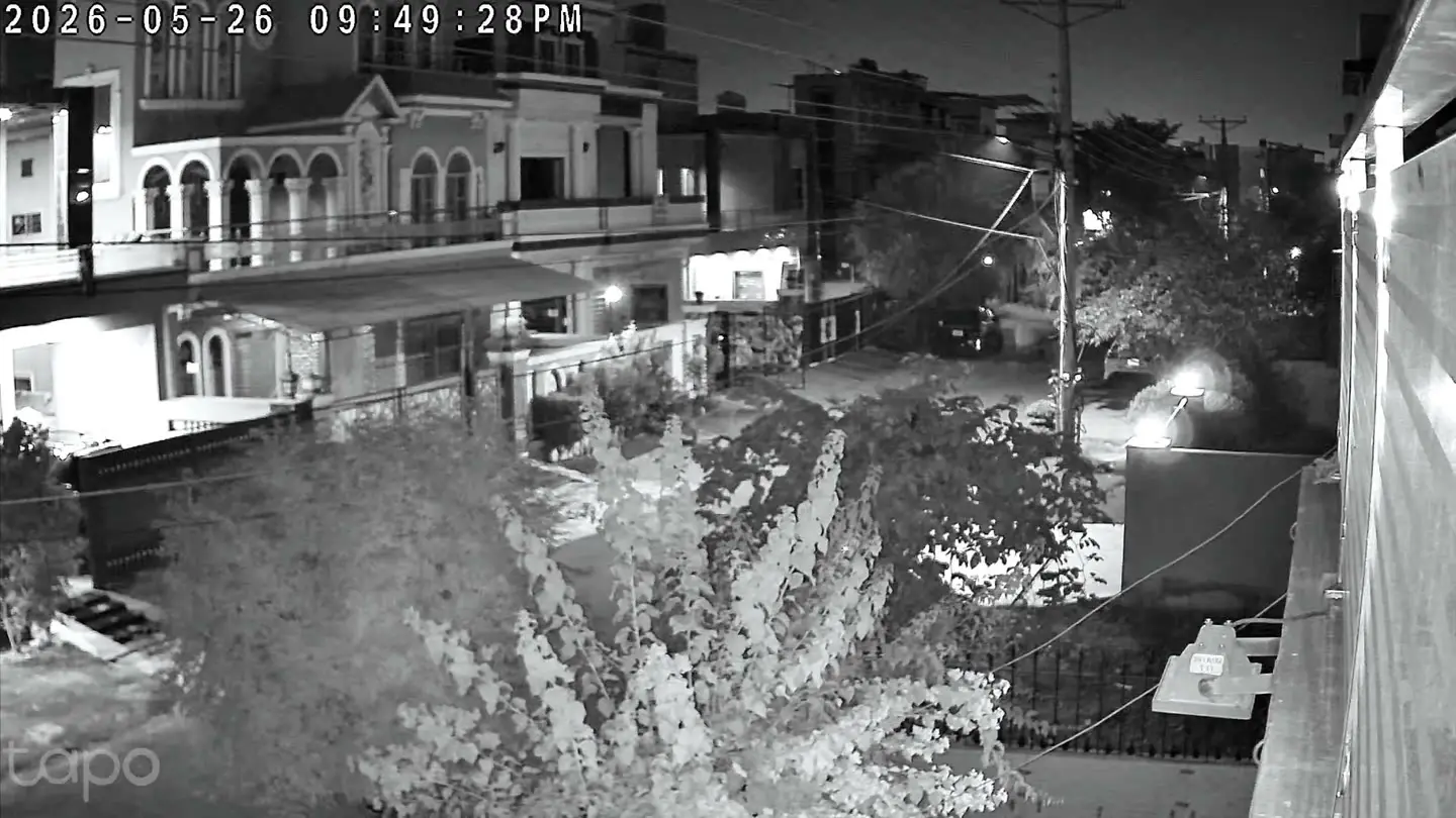 A black-and-white infrared night frame from the C645D showing a street scene captured from a distance