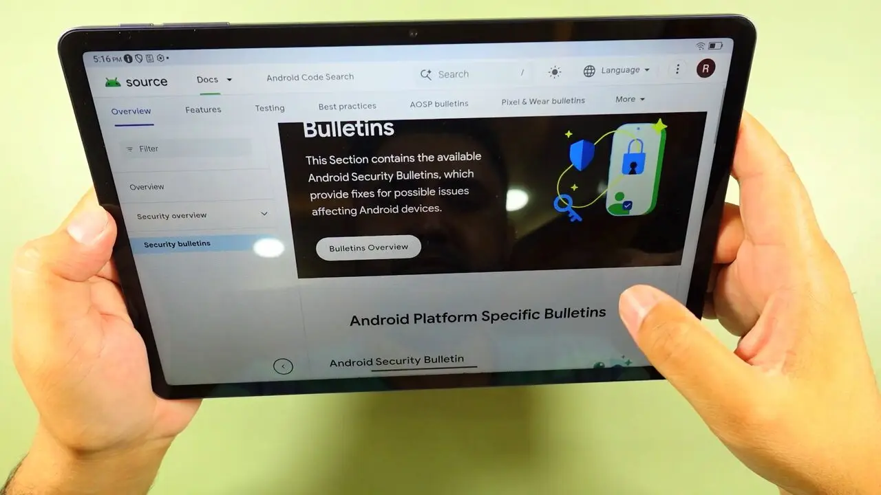 The TCL Tab A1 held in both hands showing a sharp, readable web page on its screen