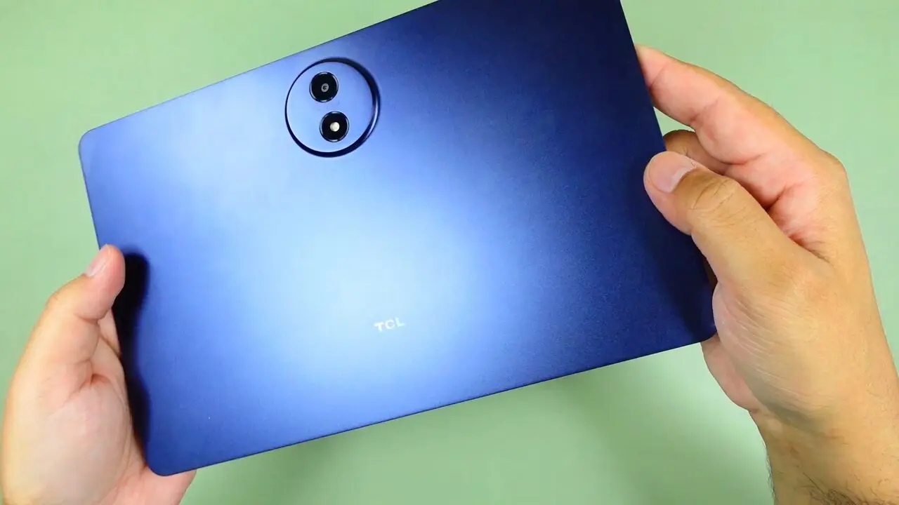 Blue metal back of the TCL Tab A1 tablet held in both hands, with the round camera module and TCL logo visible