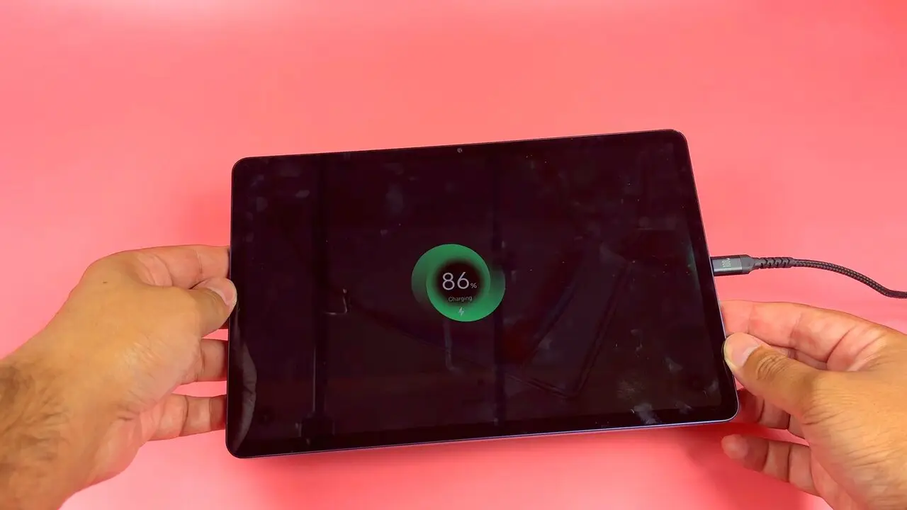 A USB-C cable plugged into the TCL Tab A1 while the screen shows a charging indicator at 86 percent