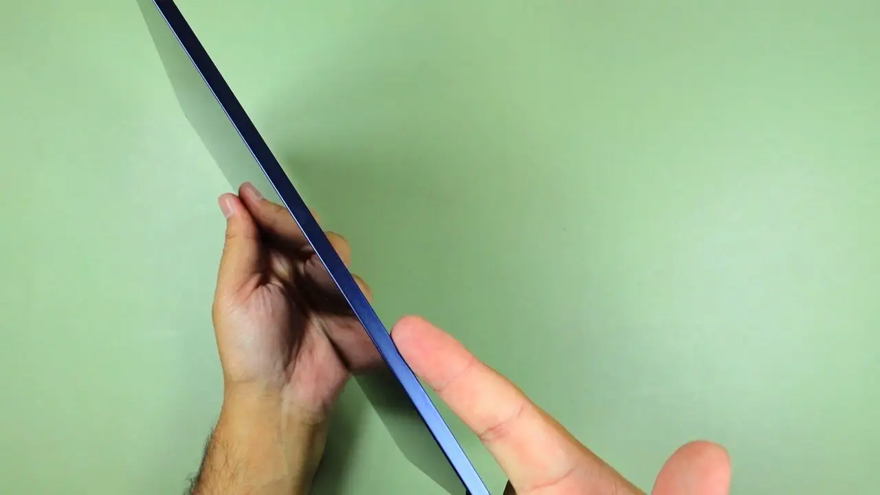 The TCL Tab A1 held on its side to show its thin metal edge