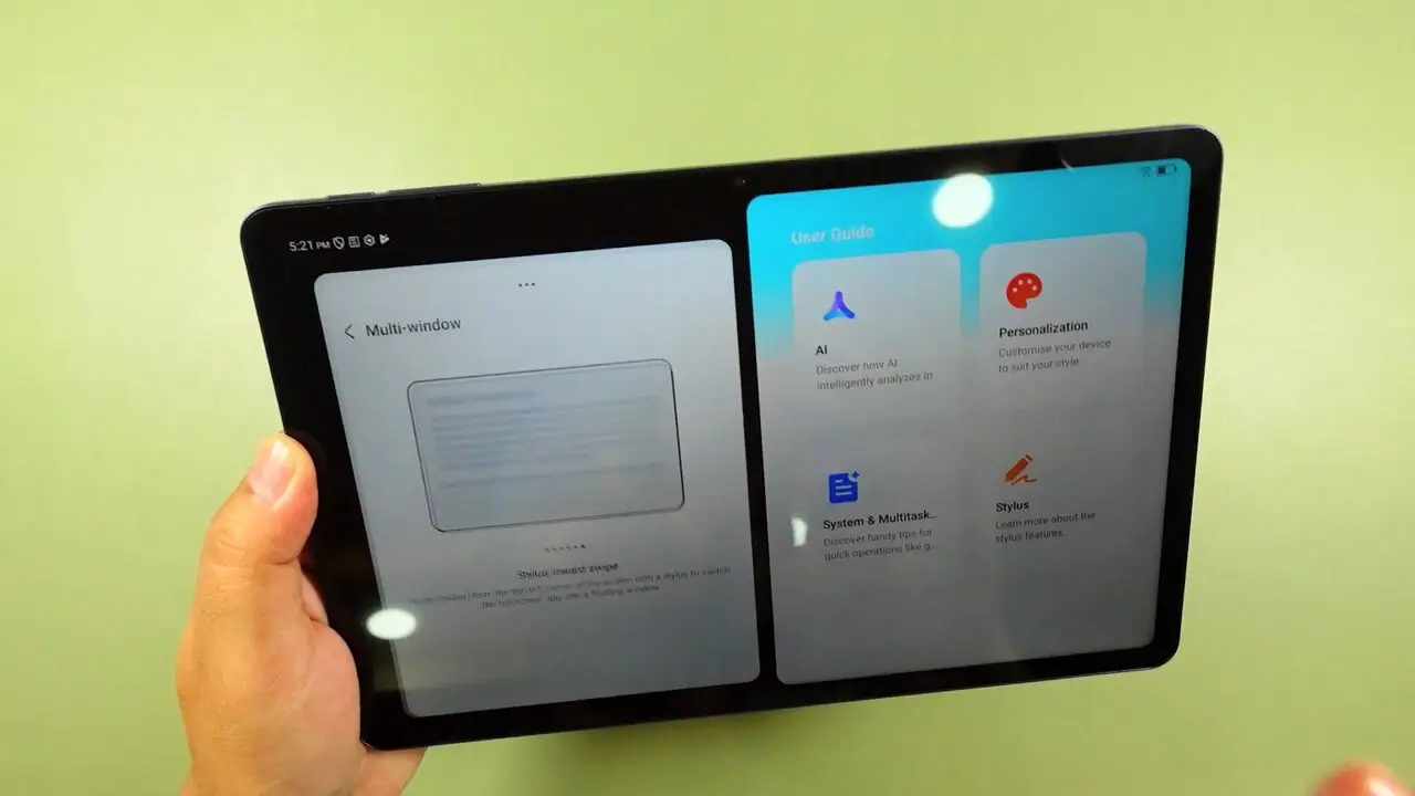 The TCL Tab A1 held in one hand showing two apps side by side in split-screen mode, with the Multi-window page on the left