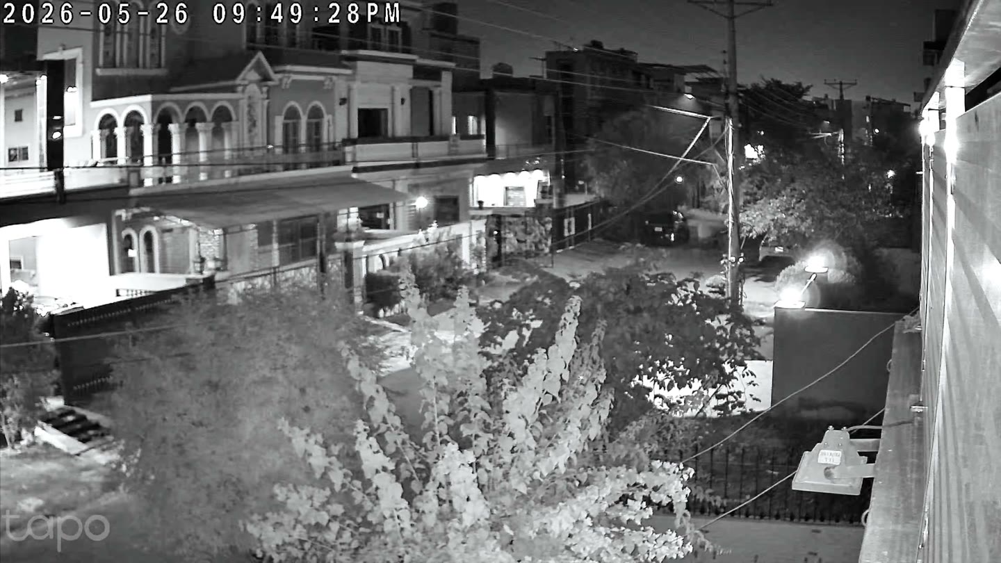 A black-and-white infrared night frame from the C645D showing a street scene captured from a distance